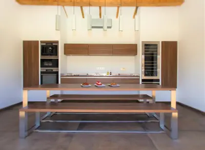 a kitchen with a large wooden table with benches at **** VILLA CASA DI FIUMU **** in Porto-Vecchio