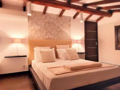 a bedroom with a large bed with two lamps at **** VILLA CASA DI FIUMU **** in Porto-Vecchio