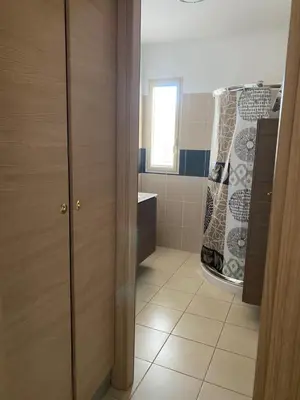 a bathroom with a shower with a shower curtain at Superbe appartement avec parking privé, proche commerces et mer in Lucciana