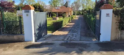 a gate to a house with a driveway at 