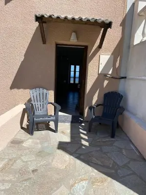 two chairs sitting on the side of a building at Levé du soleil sur la mer in Taglio-Isolaccio