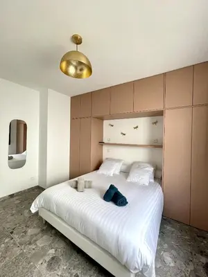 a bedroom with a large white bed with a gold ceiling at Villa U Pastore in Porticcio