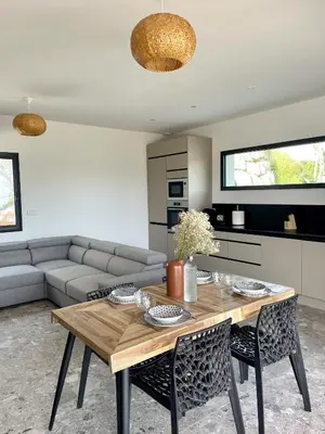 a living room with a table and a couch at Villa U Pastore in Porticcio