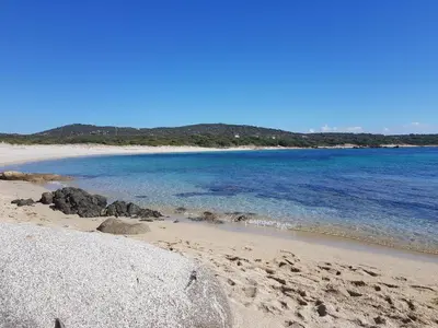 a sandy beach with rocks and the ocean at Apartment Porto Vecchio, 6 persons, 500 m beach in Zonza