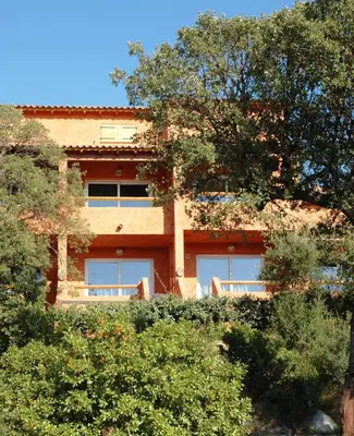 a building with trees in front of it at Apartment Porto Vecchio, 6 persons, 500 m beach in Zonza