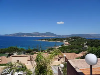 a view of the ocean from the balcony of a house at Douceur du soir - Duplex 45m2 - Terrasse - Jardinet - Wifi fibre - Plage à pied in Porticcio
