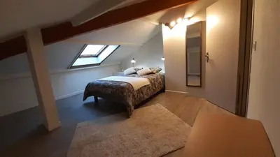 a attic bedroom with a bed and a window at Résidence Les Marines de Moriani pieds dans l'eau duplex avec terrasses vue mer, 4-8 pers in San-Nicolao