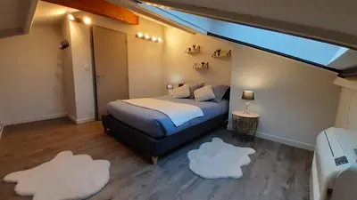 a bedroom with a bed and two white rugs at Résidence Les Marines de Moriani pieds dans l'eau duplex avec terrasses vue mer, 4-8 pers in San-Nicolao