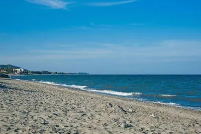 a sandy beach with the ocean in the background at Résidence Les Marines de Moriani pieds dans l'eau duplex avec terrasses vue mer, 4-8 pers in San-Nicolao