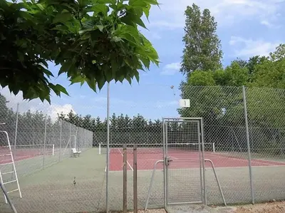 a tennis court with two tennis courts at Résidence Les Marines de Moriani pieds dans l'eau duplex avec terrasses vue mer, 4-8 pers in San-Nicolao