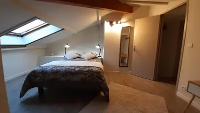 a bedroom with a large bed with a skylight at Résidence Les Marines de Moriani pieds dans l'eau duplex avec terrasses vue mer, 4-8 pers in San-Nicolao