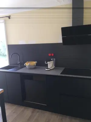 a kitchen with a black counter top with a sink at E Cabanacce in Aléria