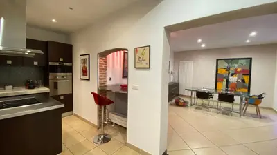 a kitchen and dining room with a table in it at T3 de 140m2 pour 7 pers- Extra centre Ajaccio - À 5 min à pied des plages - Classé 5 étoiles - CASA DI ARTISTI in Ajaccio