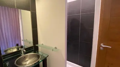 a bathroom with a sink and a mirror at T3 de 140m2 pour 7 pers- Extra centre Ajaccio - À 5 min à pied des plages - Classé 5 étoiles - CASA DI ARTISTI in Ajaccio