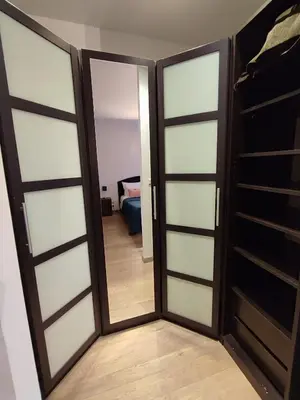 a sliding glass door with a mirror in a room at T3 de 140m2 pour 7 pers- Extra centre Ajaccio - À 5 min à pied des plages - Classé 5 étoiles - CASA DI ARTISTI in Ajaccio