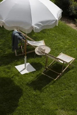 an umbrella and a chair sitting under a table at Résidence Omigna in Cargèse