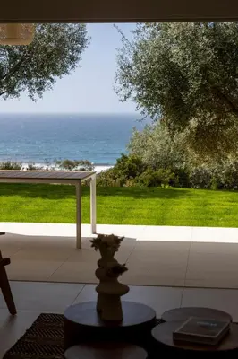 a vase on a table in front of a view of the ocean at Résidence Omigna in Cargèse