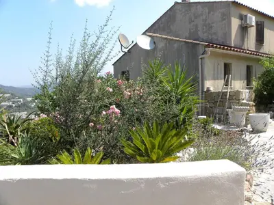 a house with flowers and plants in front of it at IN'D'NOI in Ajaccio