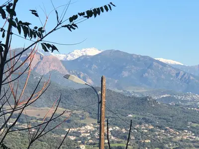 a street light with mountains in the background at IN'D'NOI in Ajaccio