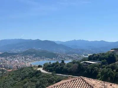 a view of a city with a river and mountains at IN'D'NOI in Ajaccio