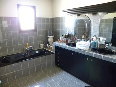 a bathroom with two sinks and a large mirror at IN'D'NOI in Ajaccio