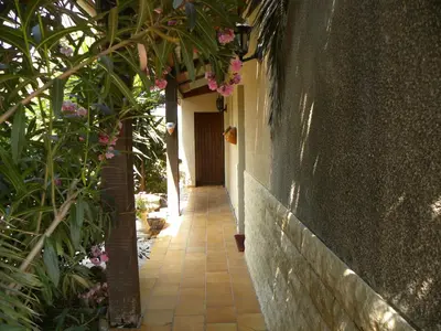 a walkway leading to a house with flowers at IN'D'NOI in Ajaccio