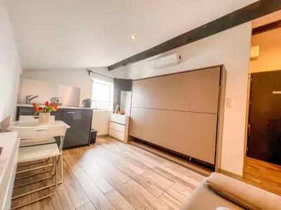 a large sliding door in a room with a kitchen at Les Studios du Pêcheur - Hypercentre - Clim - City Trip in Ajaccio