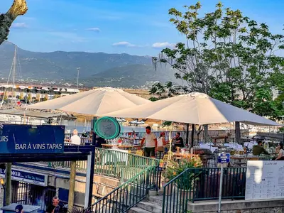 a group of umbrellas and tables in a market at Les Studios du Pêcheur - Hypercentre - Clim - City Trip in Ajaccio