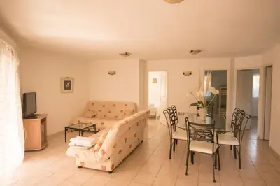 a white bathroom with a sink and a shower at Residence de tourisme Le clos des Vendanges in Moriani Plage