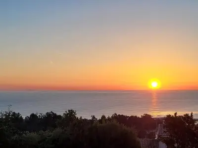 a sunset over the ocean with the sun in the sky at Superbe Villa, incroyable vue mer, avec piscine privative à Solenzara in Togna