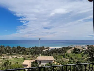 a view of the ocean from a balcony at Superbe Villa, incroyable vue mer, avec piscine privative à Solenzara in Togna