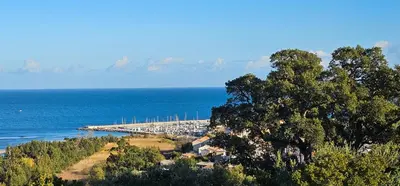 a view of a dock in the middle of the ocean at Superbe Villa, incroyable vue mer, avec piscine privative à Solenzara in Togna