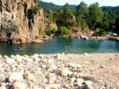 a group of people swimming in a river at Superbe Villa, incroyable vue mer, avec piscine privative à Solenzara in Togna