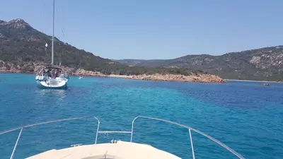 a boat in a large body of water at Superbe Villa, incroyable vue mer, avec piscine privative à Solenzara in Togna