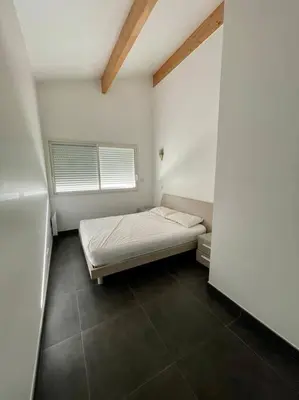 a small room with a bed and a window at APPART-SPACIEUX-VUE MER-4 PERS in Propriano