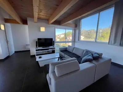 a living room with a couch and a flat screen tv at APPART-SPACIEUX-VUE MER-4 PERS in Propriano