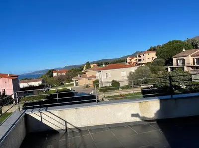 a bridge over a river with houses in the background at APPART-SPACIEUX-VUE MER-4 PERS in Propriano