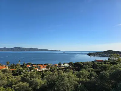 a view of a large body of water with houses at Mare E Monti Chalets in Porto Pollo