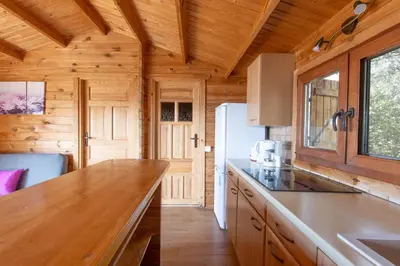 a kitchen with a counter top and a refrigerator at Mare E Monti Chalets in Porto Pollo