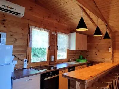 a kitchen with wooden walls and a wooden counter top at Mare E Monti Chalets in Porto Pollo