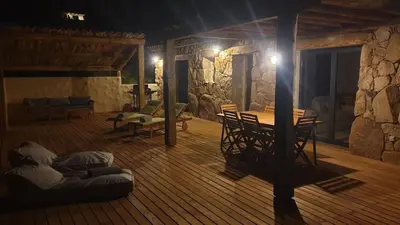 a room with a wooden floor with a table and chairs at Bergeries de charme Caselle di Conca in Conca