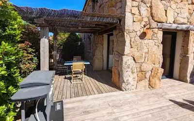 a wooden deck with a table and chairs on it at Bergeries de charme Caselle di Conca in Conca