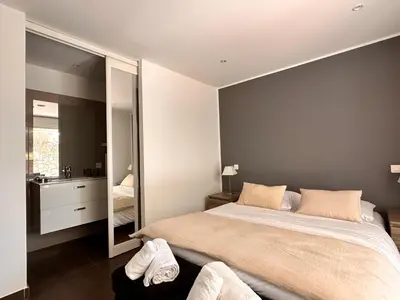 a bedroom with a large bed and a large mirror at ALTO DI PINARELLO in Sainte-Lucie de Porto-Vecchio