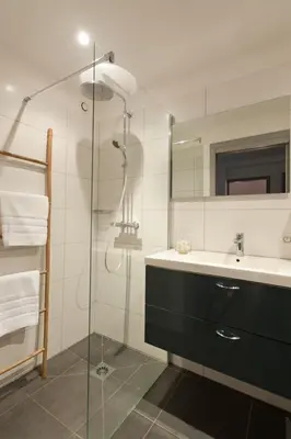 a bathroom with a glass shower and a sink at ALTO DI PINARELLO in Sainte-Lucie de Porto-Vecchio