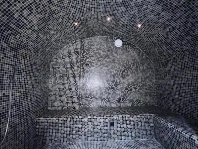 a tiled bathroom with a bath tub with a spotlight at Superbe maison dans village au coeur de la Corse A casa Suttana in Verdese