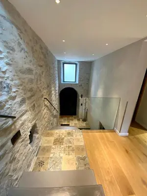 a room with a stone wall with a window at Superbe maison dans village au coeur de la Corse A casa Suttana in Verdese