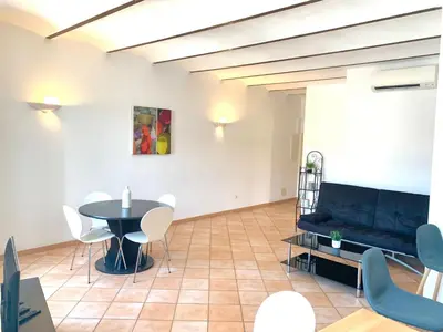 a living room with a table and a couch at Appartements Bonifacio AcquaViva in Bonifacio