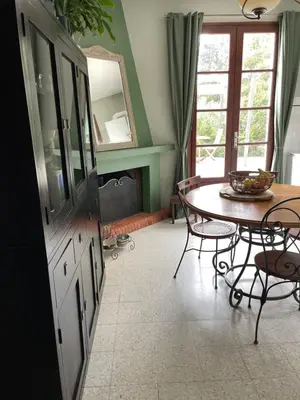 a kitchen with a table and a dining room at Villa près de la Plage in Grosseto-Prugna