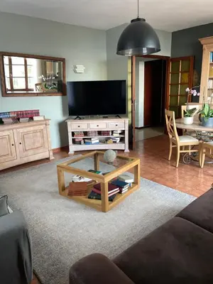 a living room with a tv and a coffee table at Villa près de la Plage in Grosseto-Prugna