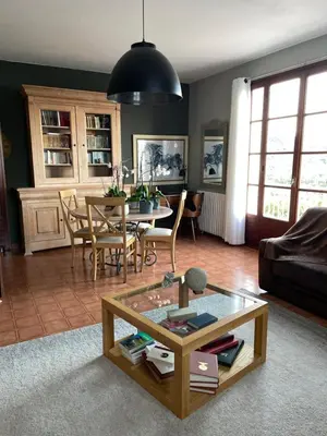 a living room with a table and a dining room at Villa près de la Plage in Grosseto-Prugna